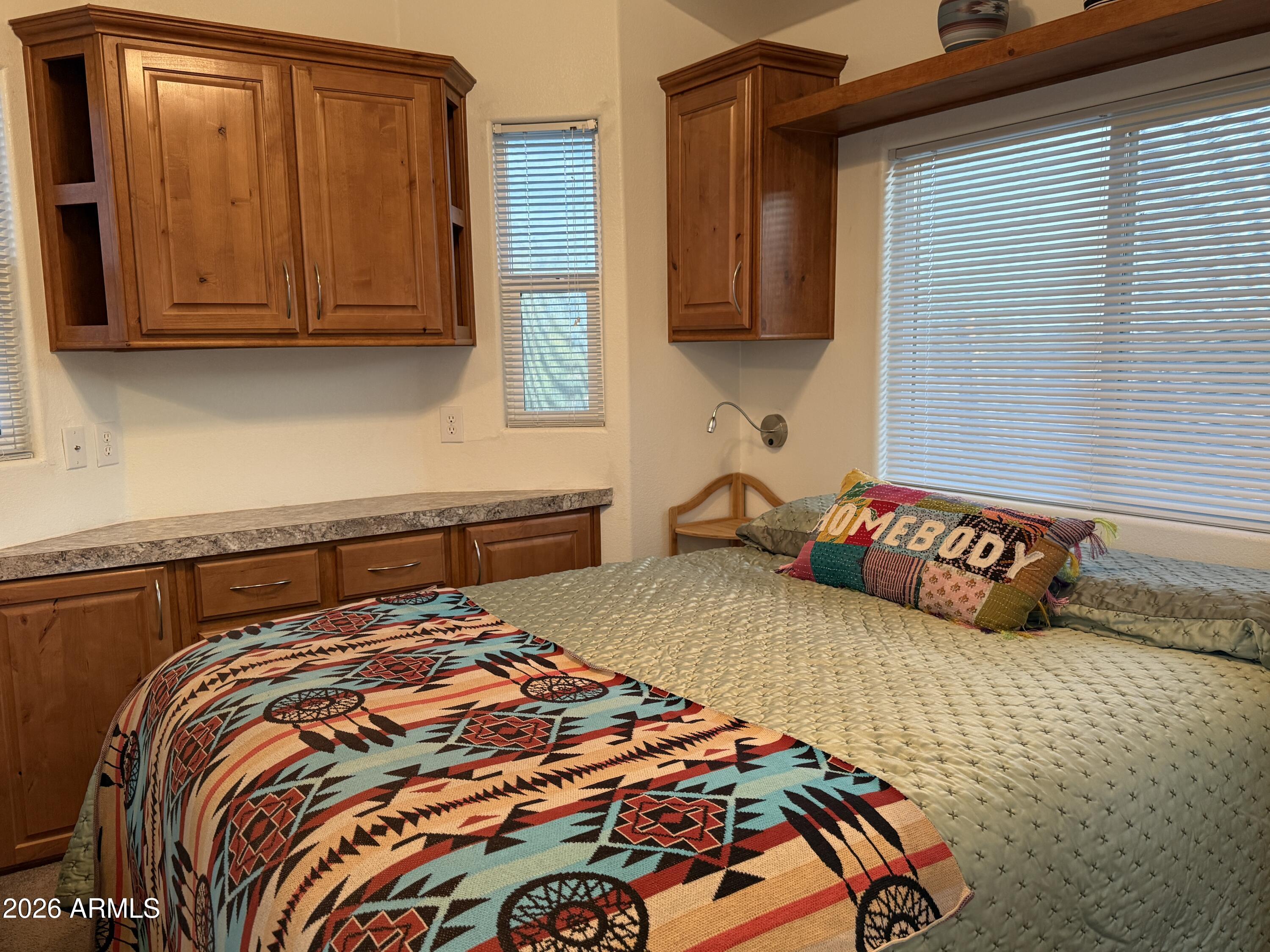 21245 Westward View Road, Unit 248 Congress, AZ 85332 - Photo 13 of 28 a bedroom with a bed and cupboard