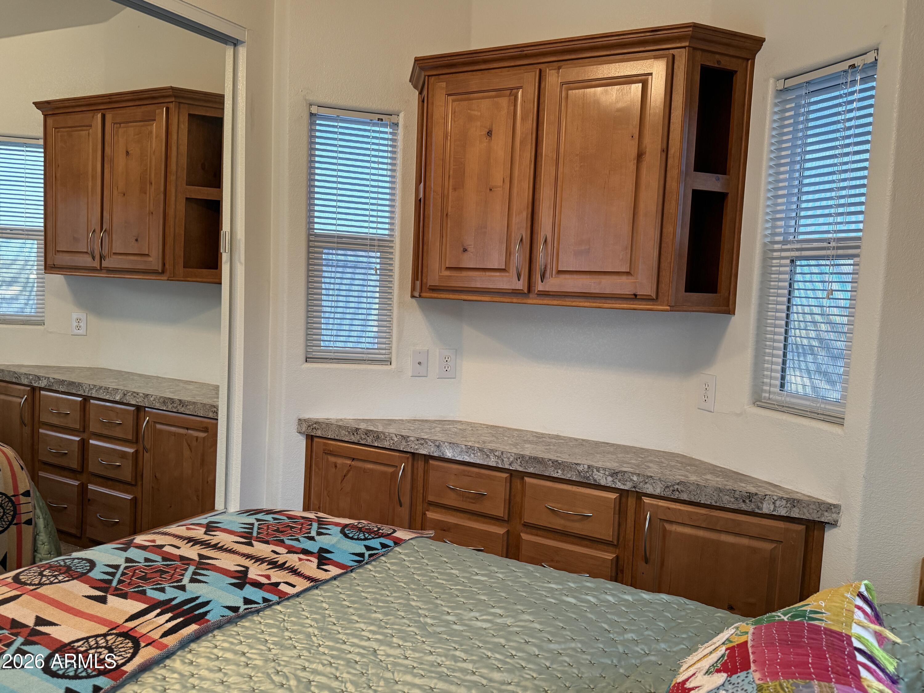 21245 Westward View Road, Unit 248 Congress, AZ 85332 - Photo 14 of 28 a bedroom with a bed and cabinets