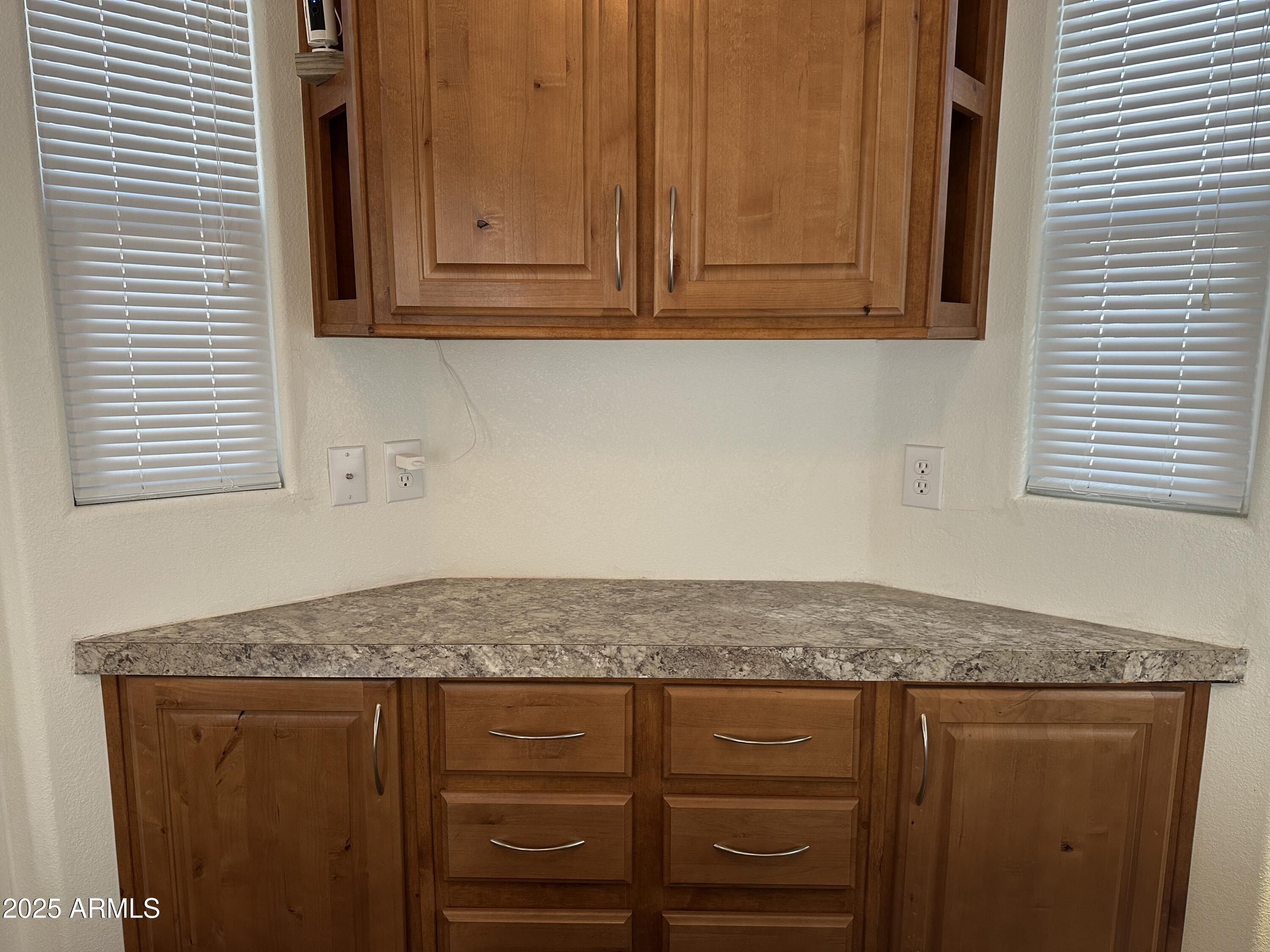 21245 Westward View Road, Unit 248 Congress, AZ 85332 - Photo 16 of 28 a kitchen with granite countertop cabinets and black appliances
