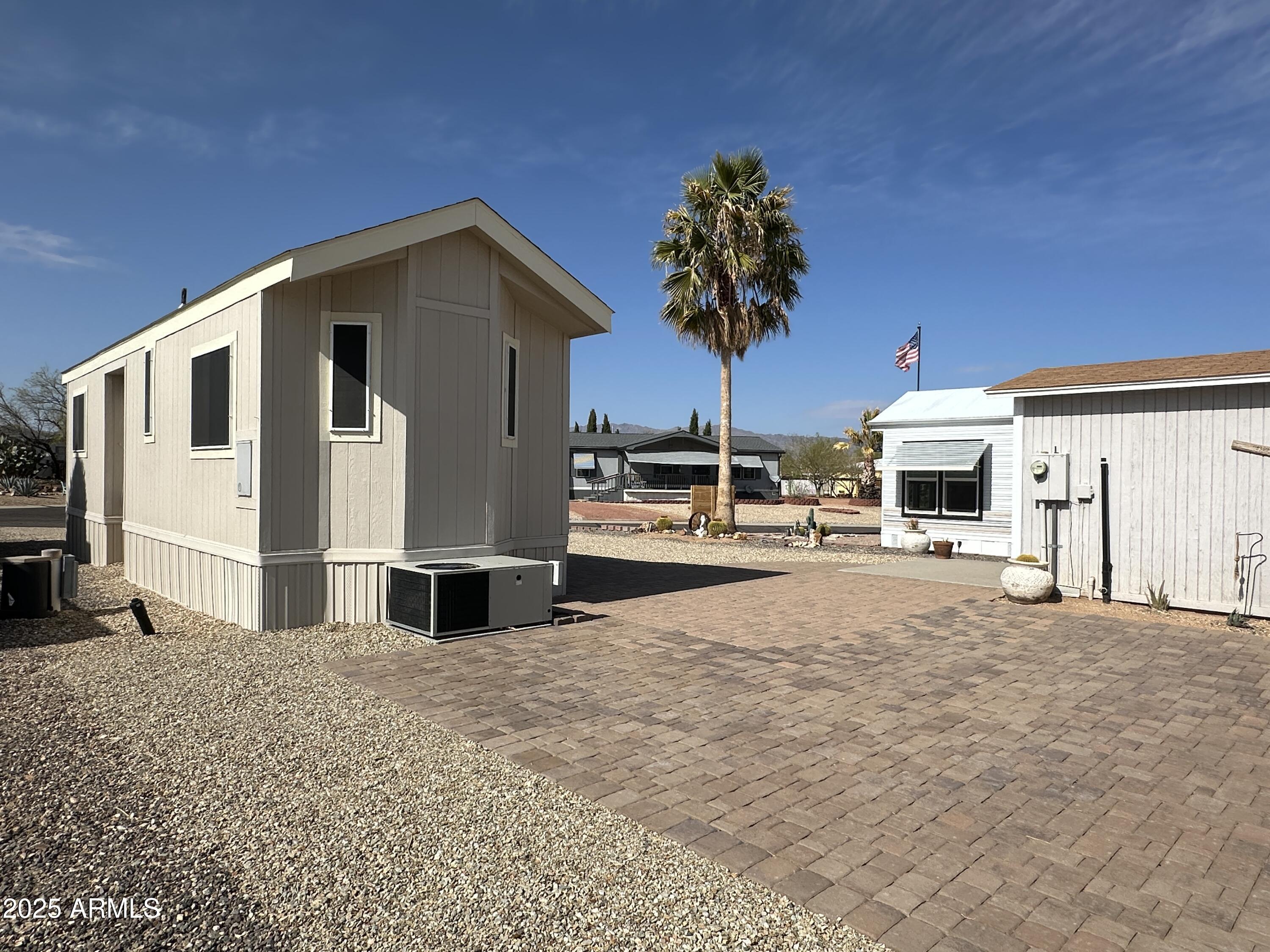 21245 Westward View Road, Unit 248 Congress, AZ 85332 - Photo 24 of 28 a house with a large window and palm tree