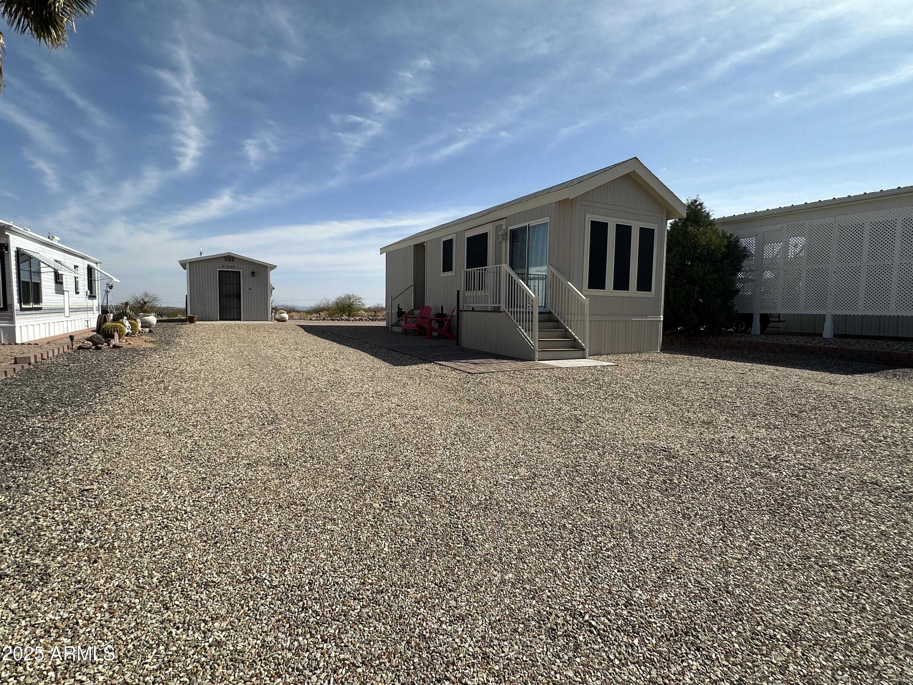 21245 Westward View Road, Unit 248 Congress, AZ 85332 - Photo 26 of 28 a front view of a house with a yard