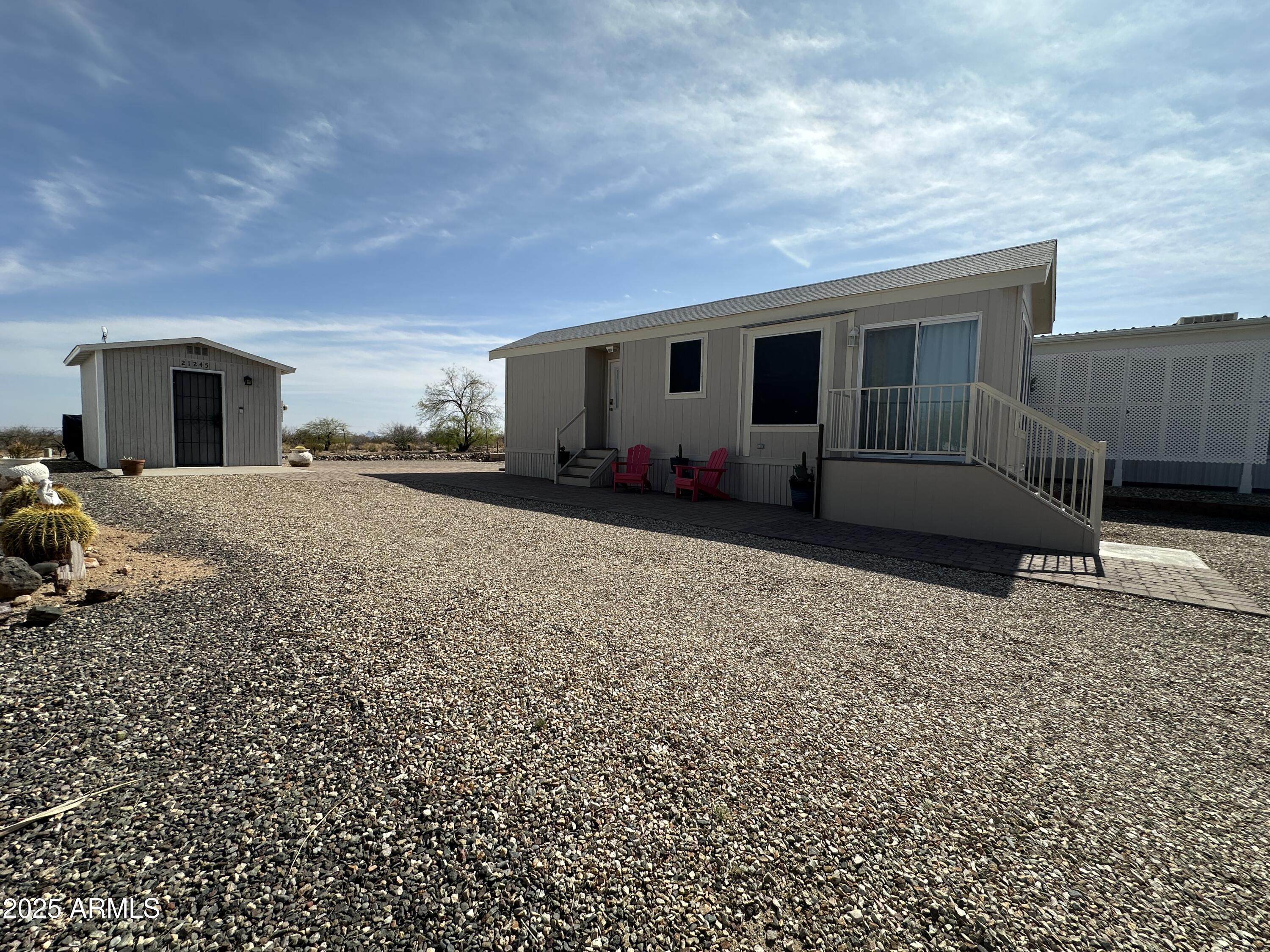 21245 Westward View Road, Unit 248 Congress, AZ 85332 - Photo 27 of 28 a front view of a house with a yard