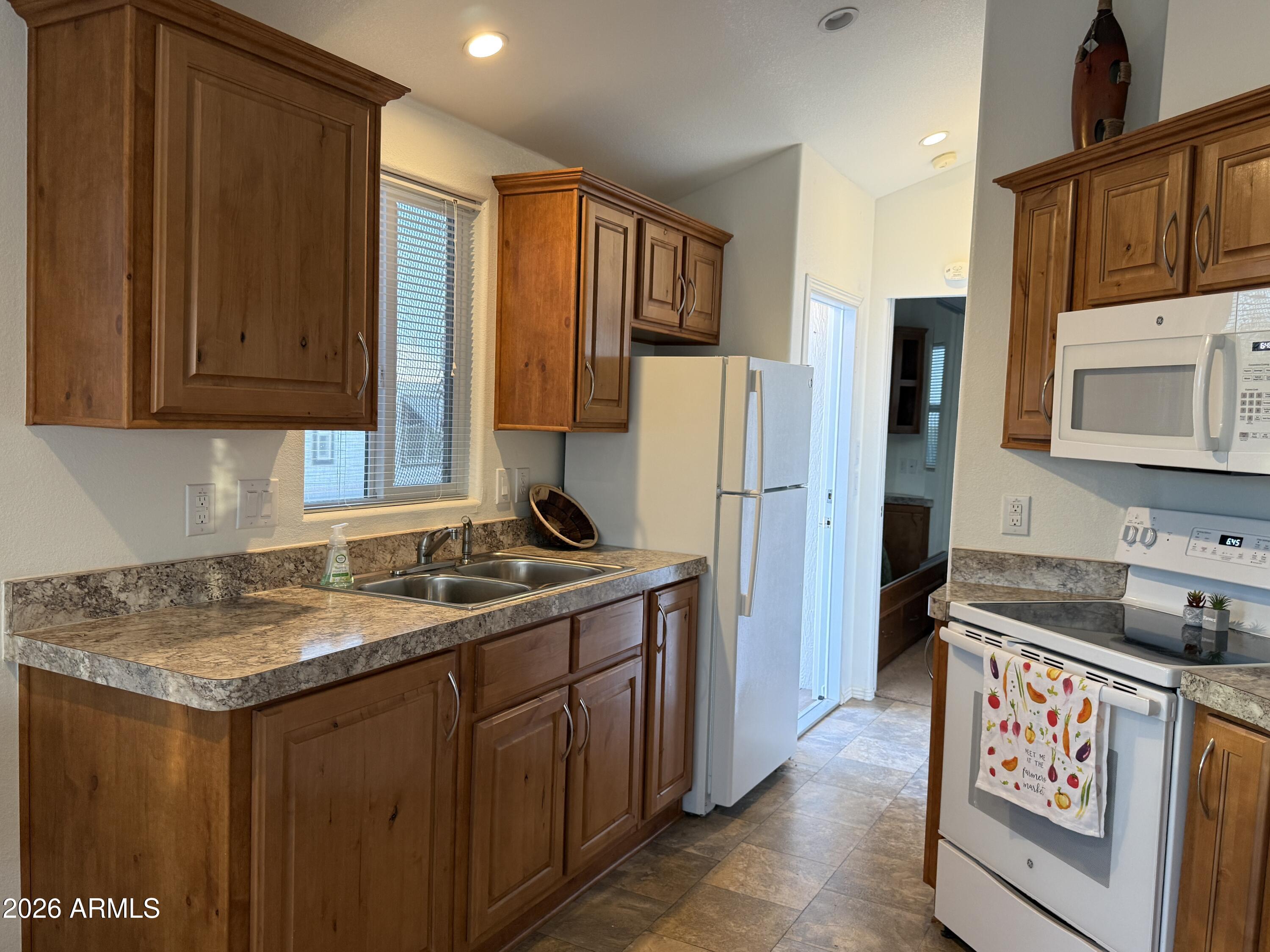 21245 Westward View Road, Unit 248 Congress, AZ 85332 - Photo 4 of 28 a kitchen with a refrigerator and a sink