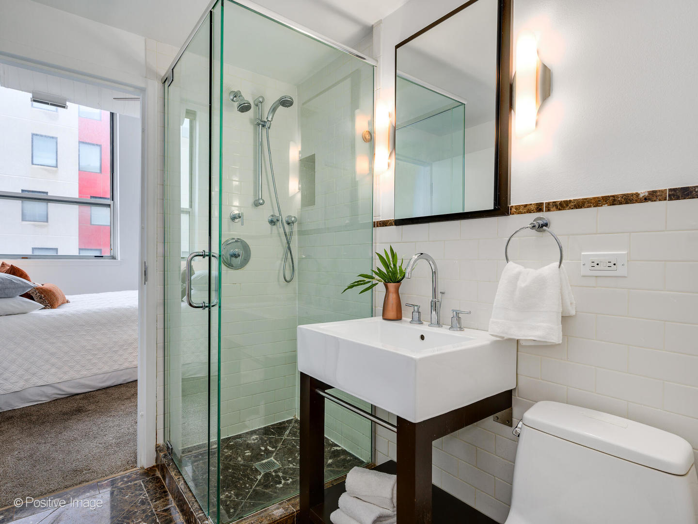 1019 West Jackson Boulevard, Unit 2B Chicago, IL 60607 - Photo 19 of 22 a bathroom with a sink toilet and shower