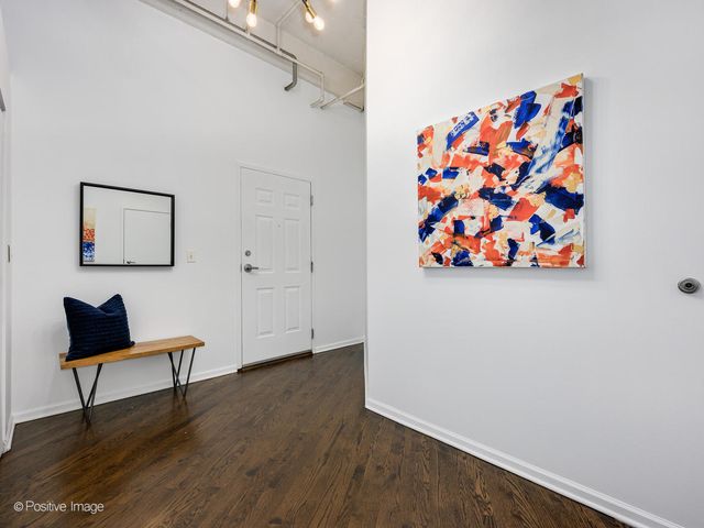 a view of room with hardwood floor and lamp on a table