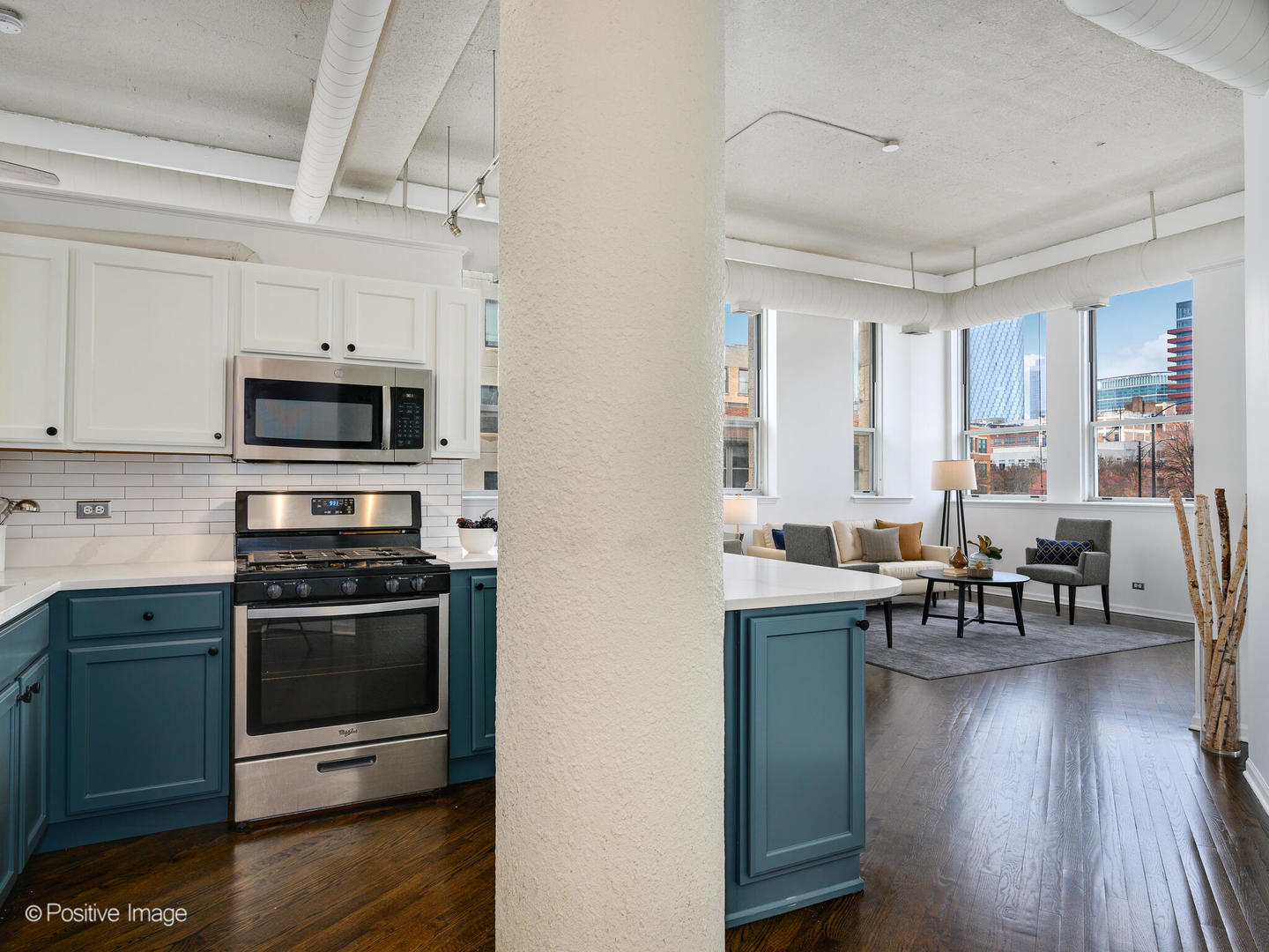 1019 West Jackson Boulevard, Unit 2B Chicago, IL 60607 - Photo 4 of 22 a kitchen with stainless steel appliances a stove a sink and a microwave