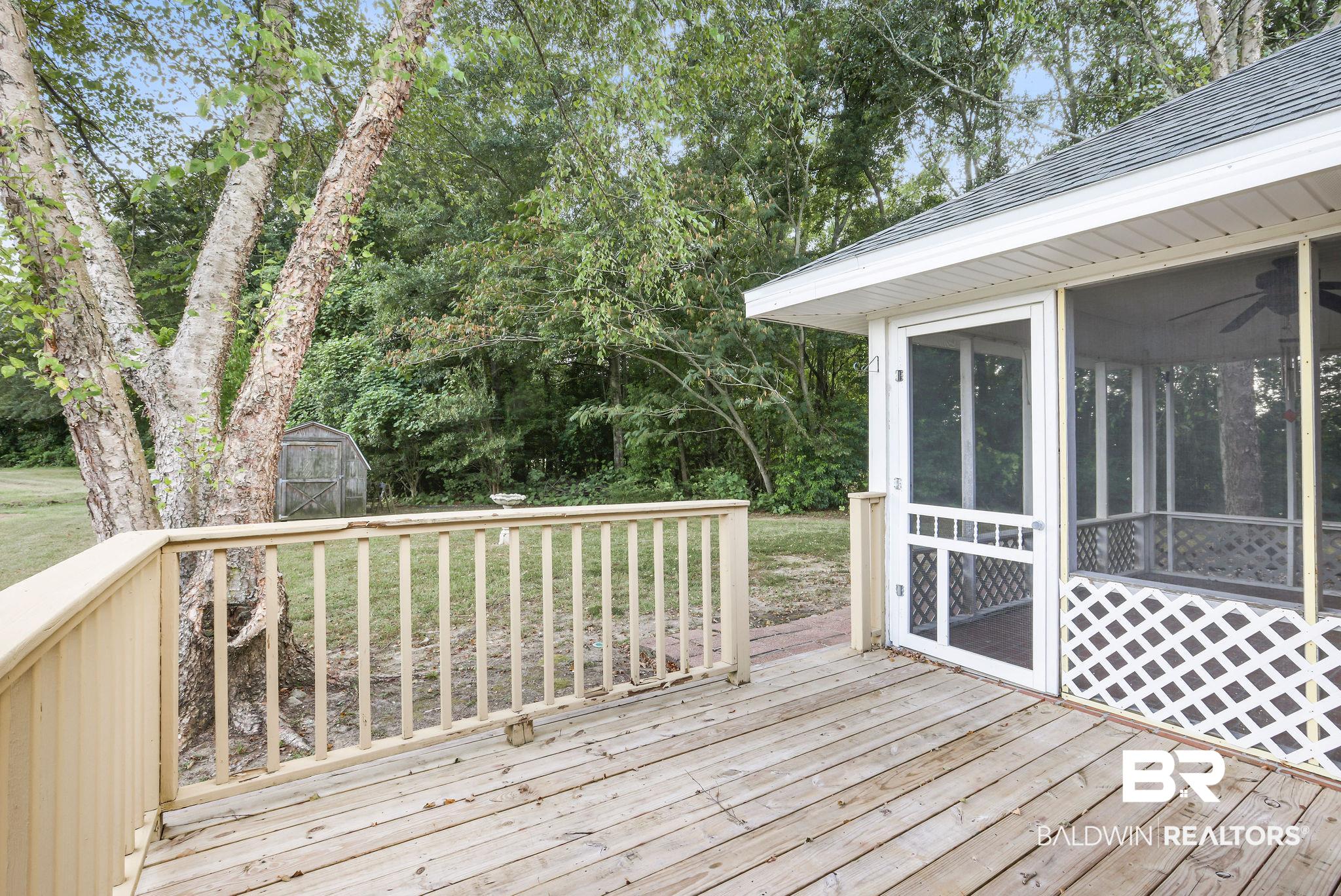 18620 Hammond Street Robertsdale, AL 36567 - Photo 19 of 23 Deck with a sunroom and a storage unit
