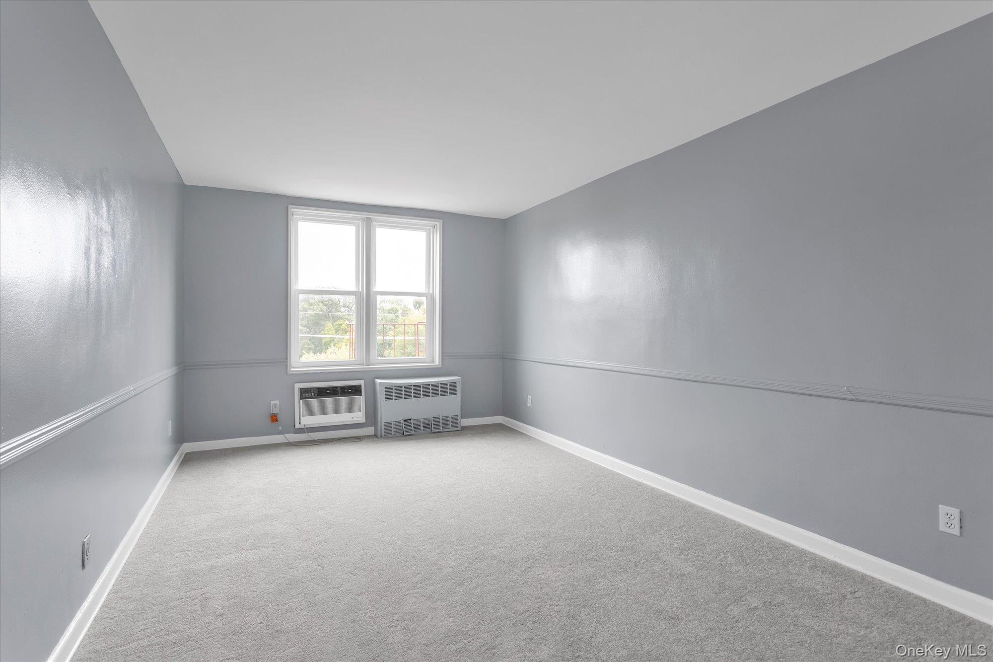 504 Merrick Road, Unit 4J Lynbrook, NY 11563 - Photo 10 of 28 an empty room with windows