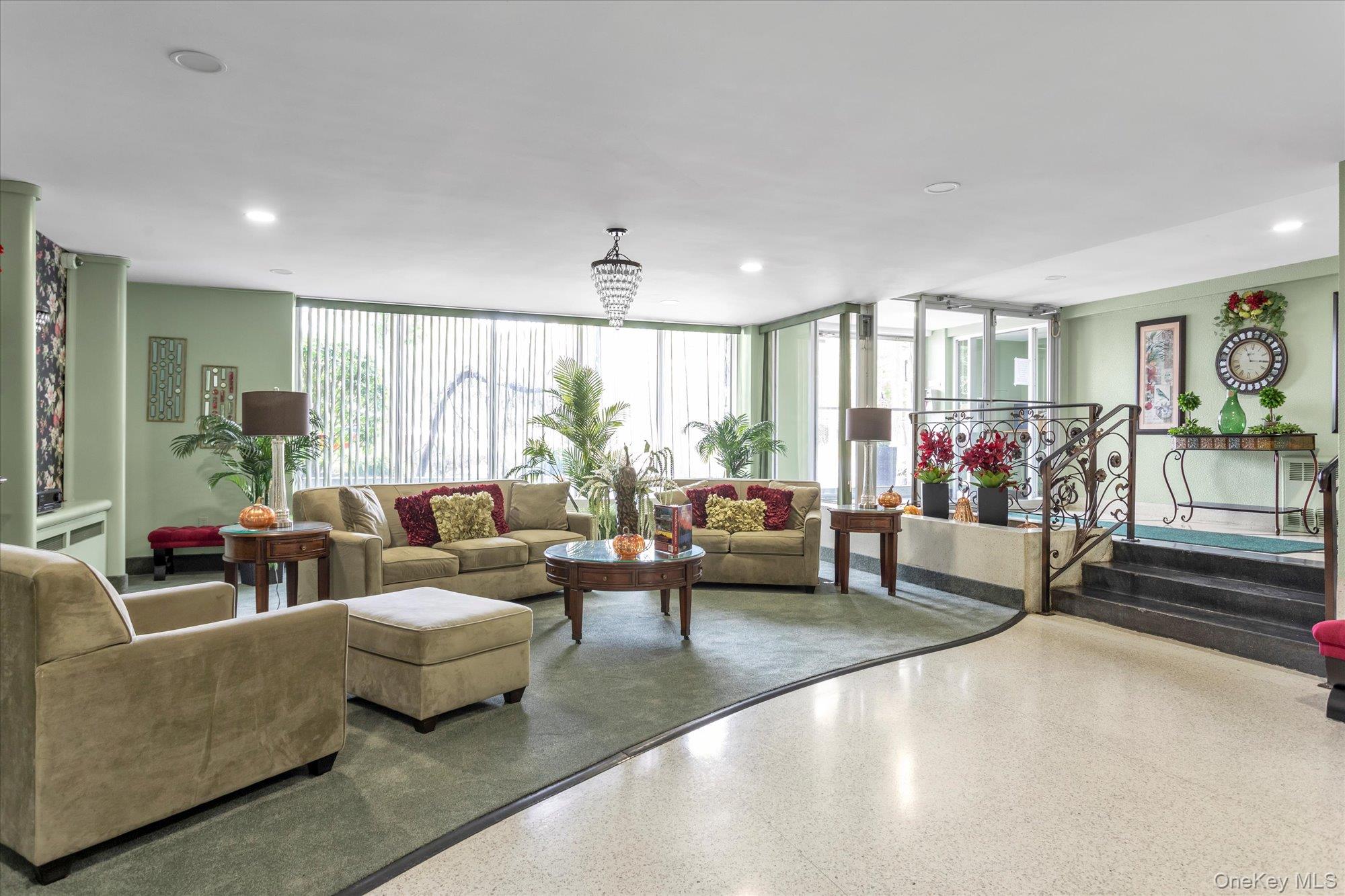 504 Merrick Road, Unit 4J Lynbrook, NY 11563 - Photo 19 of 28 a living room with furniture and a flat screen tv