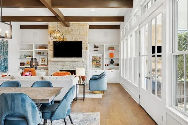 a living room with furniture a flat screen tv and a fireplace