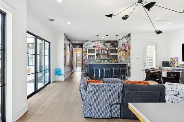 a living room with furniture a ceiling fan and a window