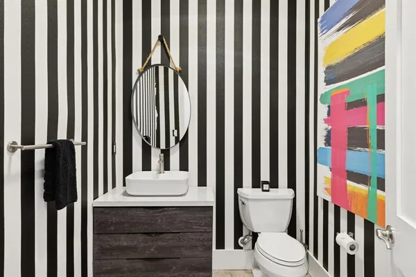 a bathroom with a toilet a sink and a shower curtain