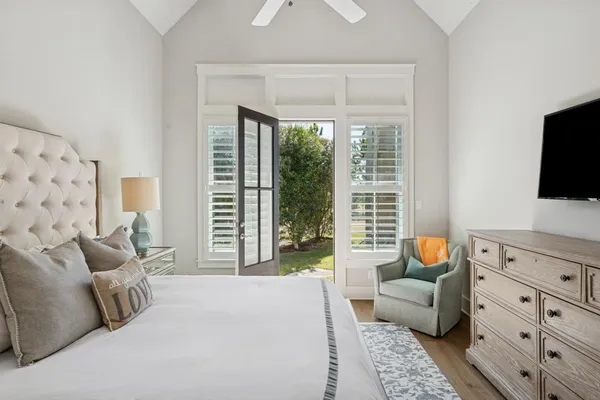 a bedroom with furniture and a flat screen tv