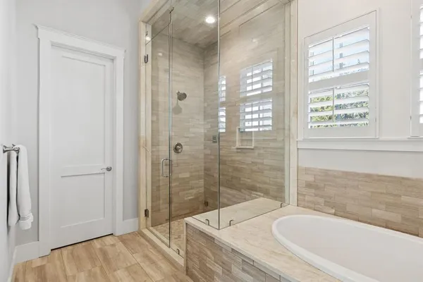 a bathroom with a granite countertop tub sink and shower