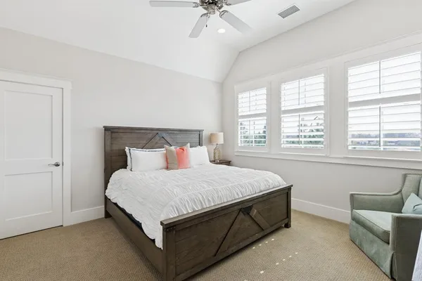 a bedroom with a bed and a couch