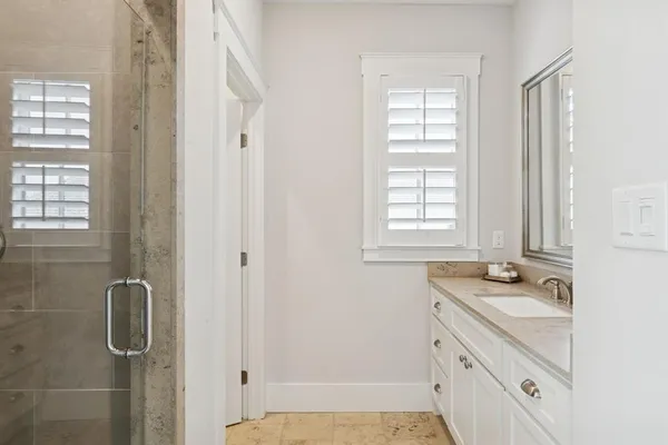 a bathroom with a sink a vanity and a window