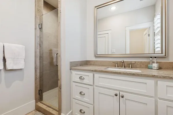 a bathroom with a granite countertop sink a mirror and a
