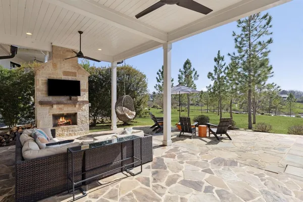 a living room with patio fireplace and a flat screen tv