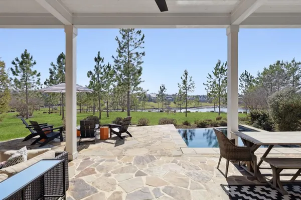 a view of a patio with chairs and table in patio