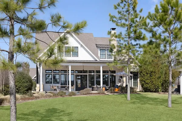 a view of a house with a yard and sitting area