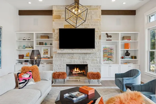 a living room with furniture a fireplace and a flat screen tv