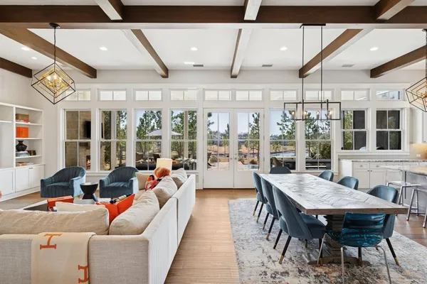 a living room with furniture a rug and a large window