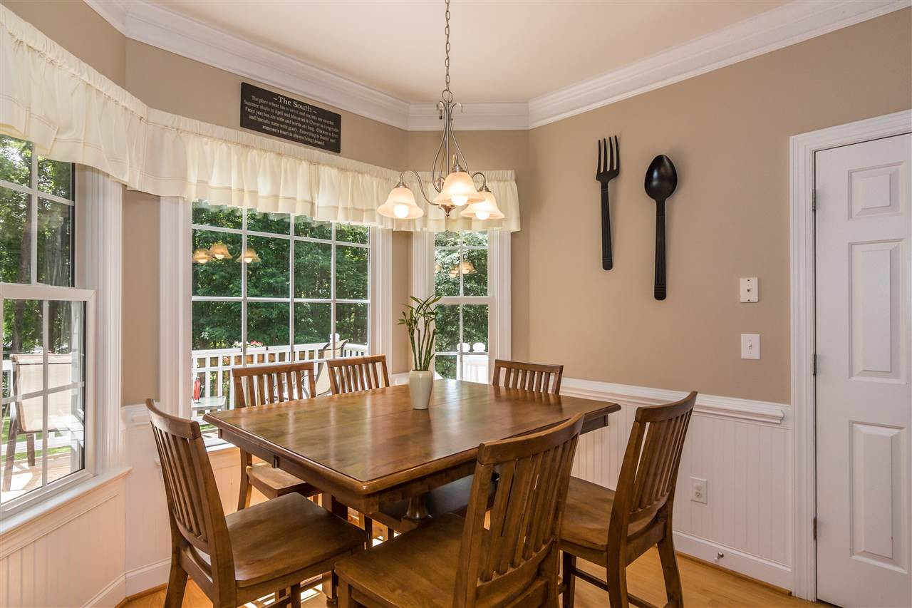 1132 Rhea Drive Garner, NC 27529 - Photo 7 of 25 Enjoy your morning coffee and casual family meals in this charming breakfast nook, complete with beadboard trim and a lovely view of the wooded backyard. Breakfast Area