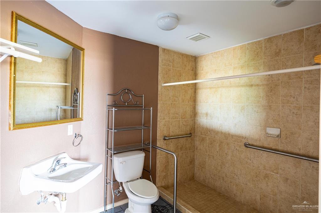 2415 East Expressway 83 Mission, TX 78572 - Photo 15 of 17 a white toilet sitting next to a bathroom sink