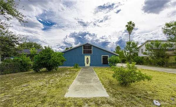 a view of backyard of house with green space