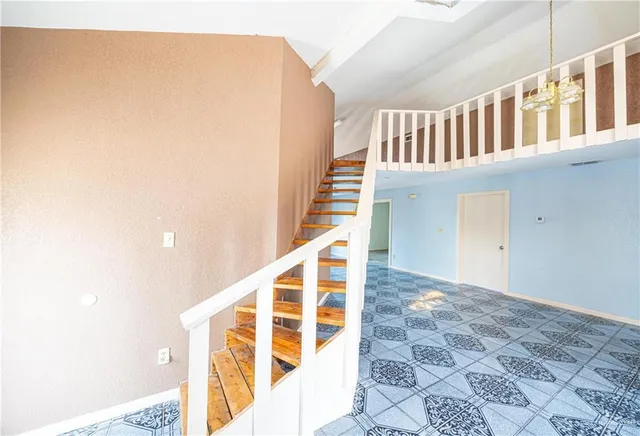 a large kitchen with a stove a refrigerator and a sink