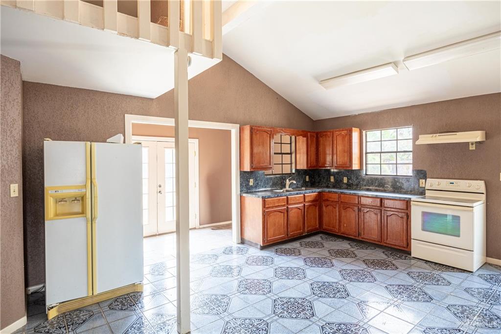 2415 East Expressway 83 Mission, TX 78572 - Photo 8 of 17 a large kitchen with a stove a refrigerator and a sink