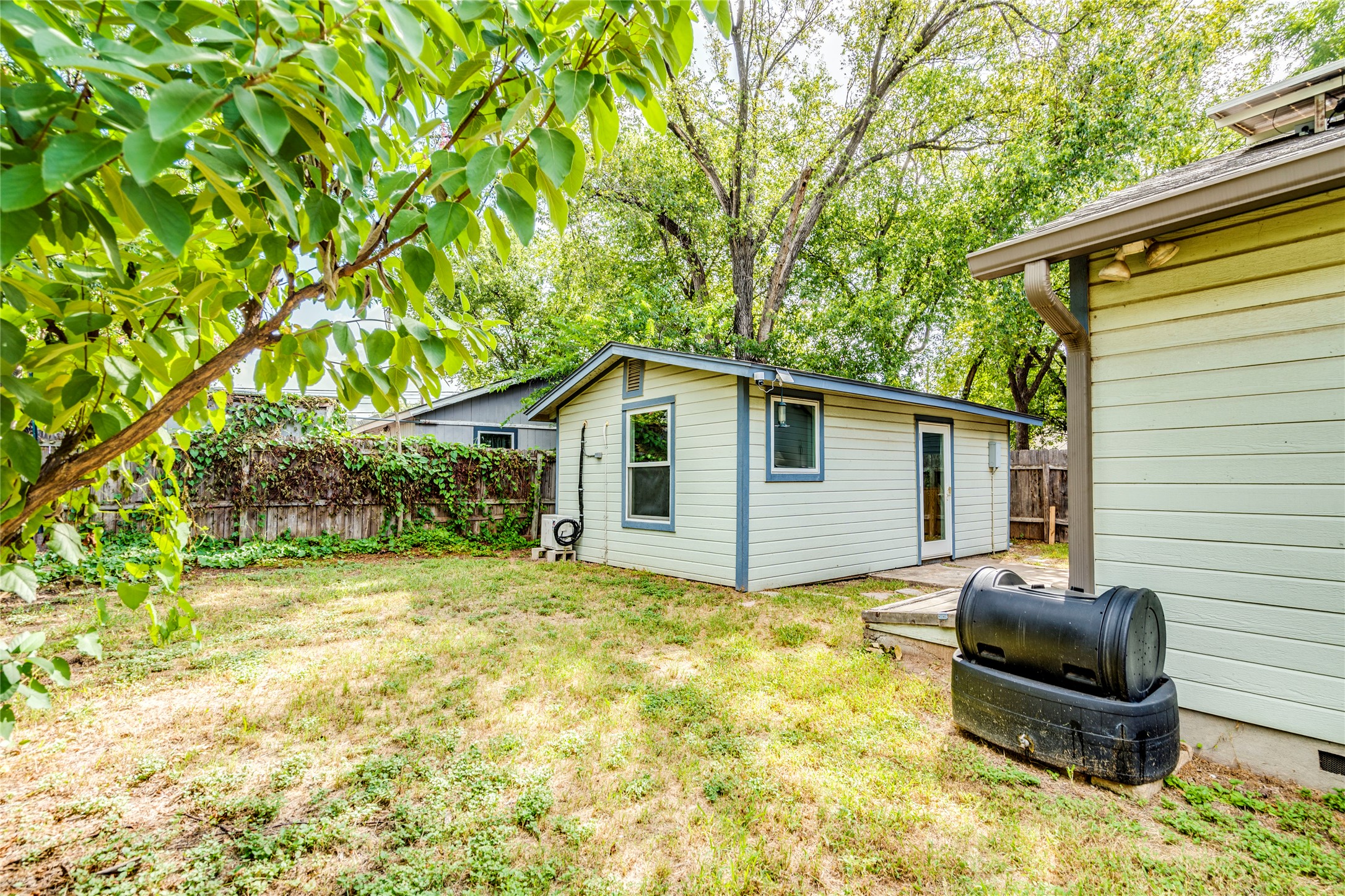2314 Santa Rosa Street Austin, TX 78702 - Photo 20 of 29 A quaint detached structure offers versatile space within a verdant, fenced yard.