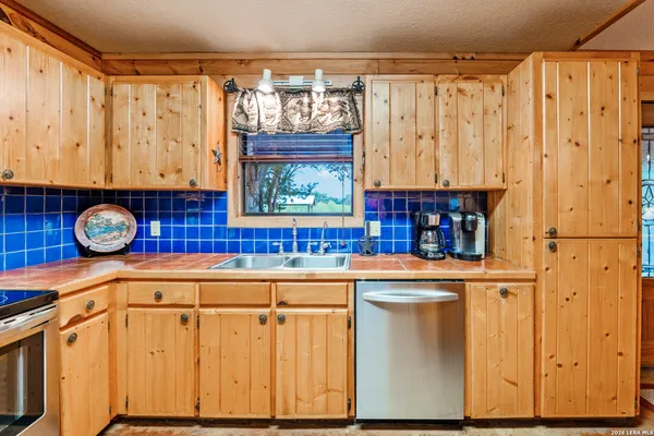 a kitchen with a refrigerator and a sink