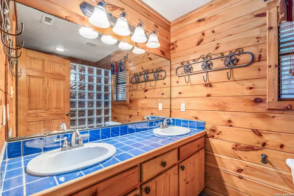 a utility room with stainless steel appliances wooden floor and chandelier