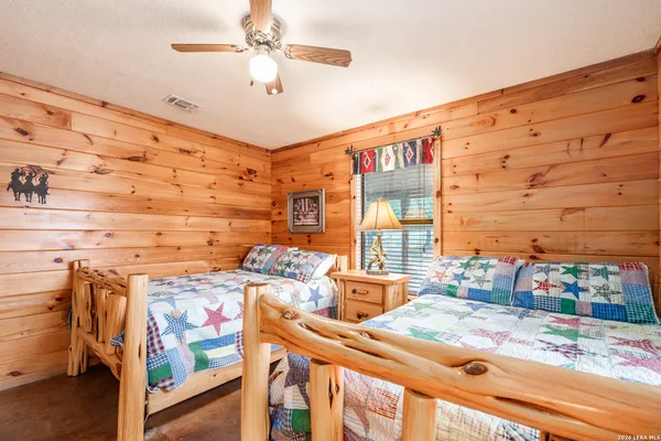 a bathroom with a double vanity sink toilet mirror and shower
