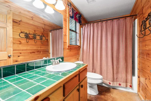 a living room with fireplace furniture and a flat screen tv