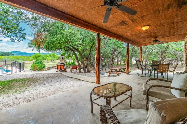 a view of a park with benches and a large tree