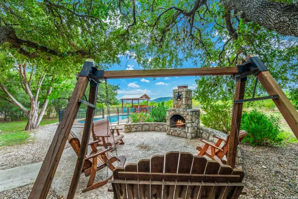 a view of a house with backyard and sitting area