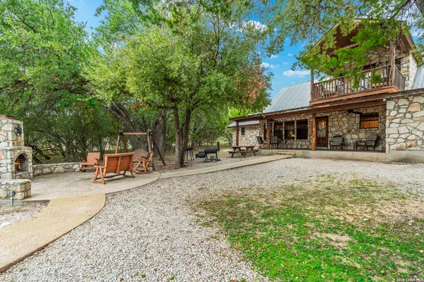 a house view with swimming pool in front of the house