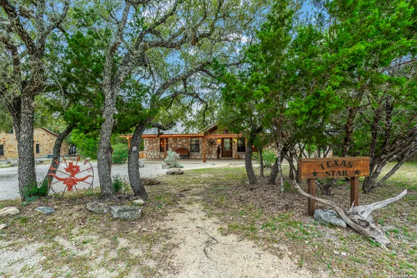 a backyard of a house with barbeque oven table and chairs