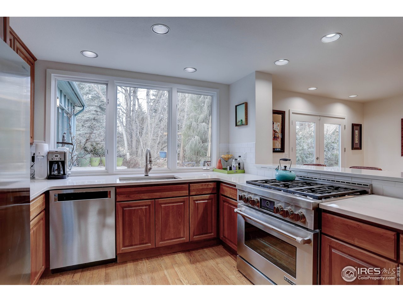 603 Kalmia Avenue Boulder, CO 80304 - Photo 12 of 39 a kitchen with stainless steel appliances granite countertop a stove a sink dishwasher and a microwave oven with large countertops