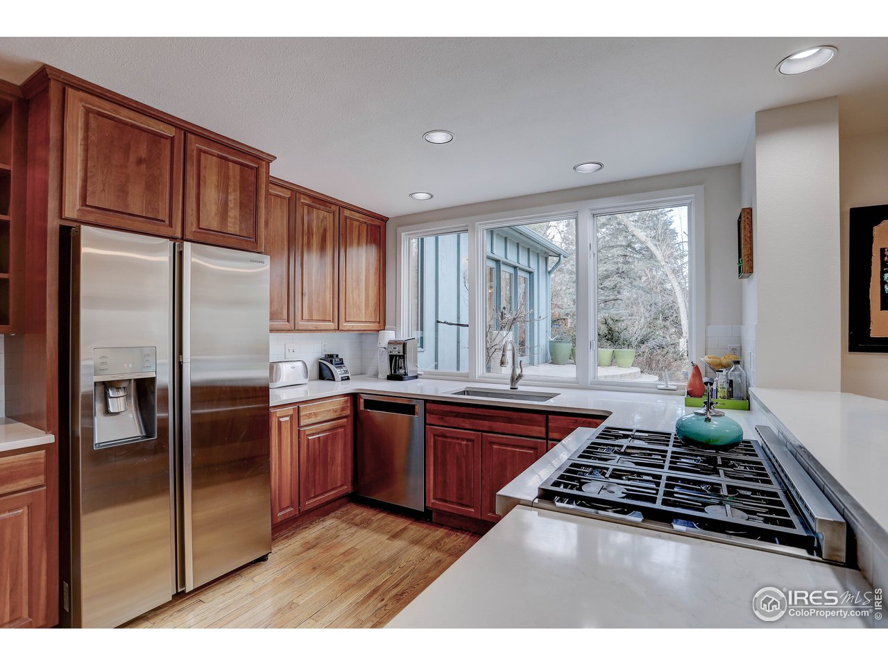 603 Kalmia Avenue Boulder, CO 80304 - Photo 13 of 39 a kitchen with stainless steel appliances granite countertop a stove a refrigerator and a sink