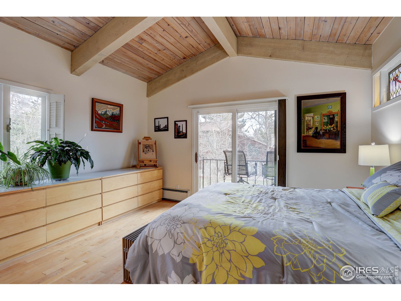 603 Kalmia Avenue Boulder, CO 80304 - Photo 19 of 39 a bedroom with a large bed and a dresser