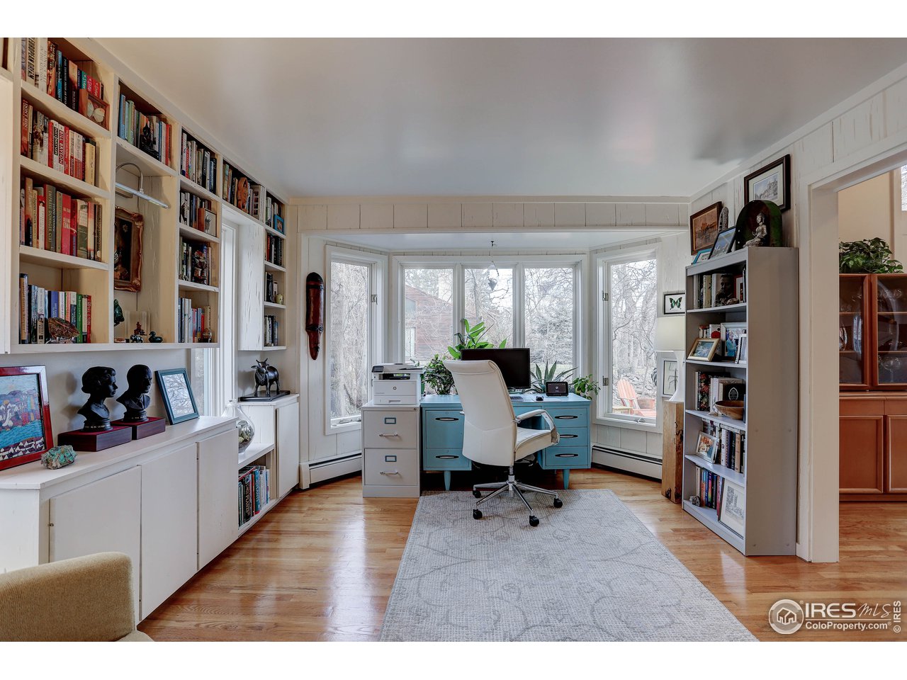 603 Kalmia Avenue Boulder, CO 80304 - Photo 26 of 39 a living room with lots of furniture and a book shelf