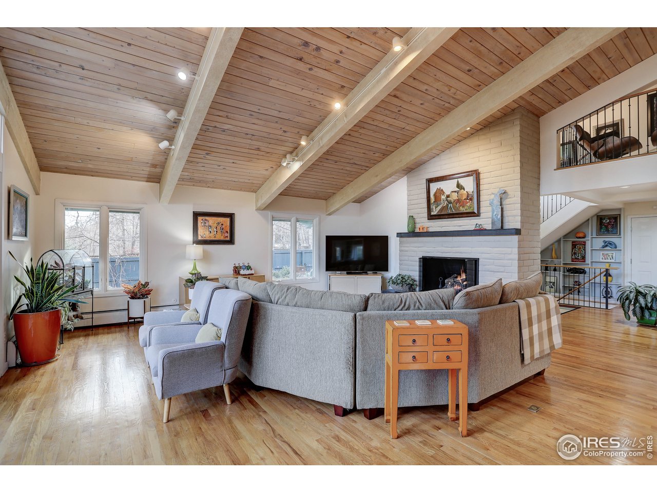 603 Kalmia Avenue Boulder, CO 80304 - Photo 7 of 39 a living room with furniture a fireplace and a flat screen tv