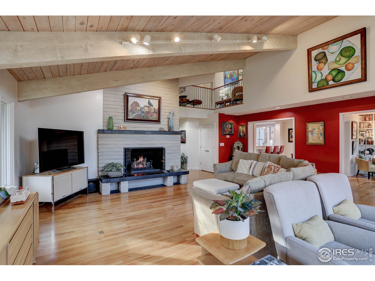 603 Kalmia Avenue Boulder, CO 80304 - Photo 8 of 39 a living room with furniture a fireplace and a flat screen tv