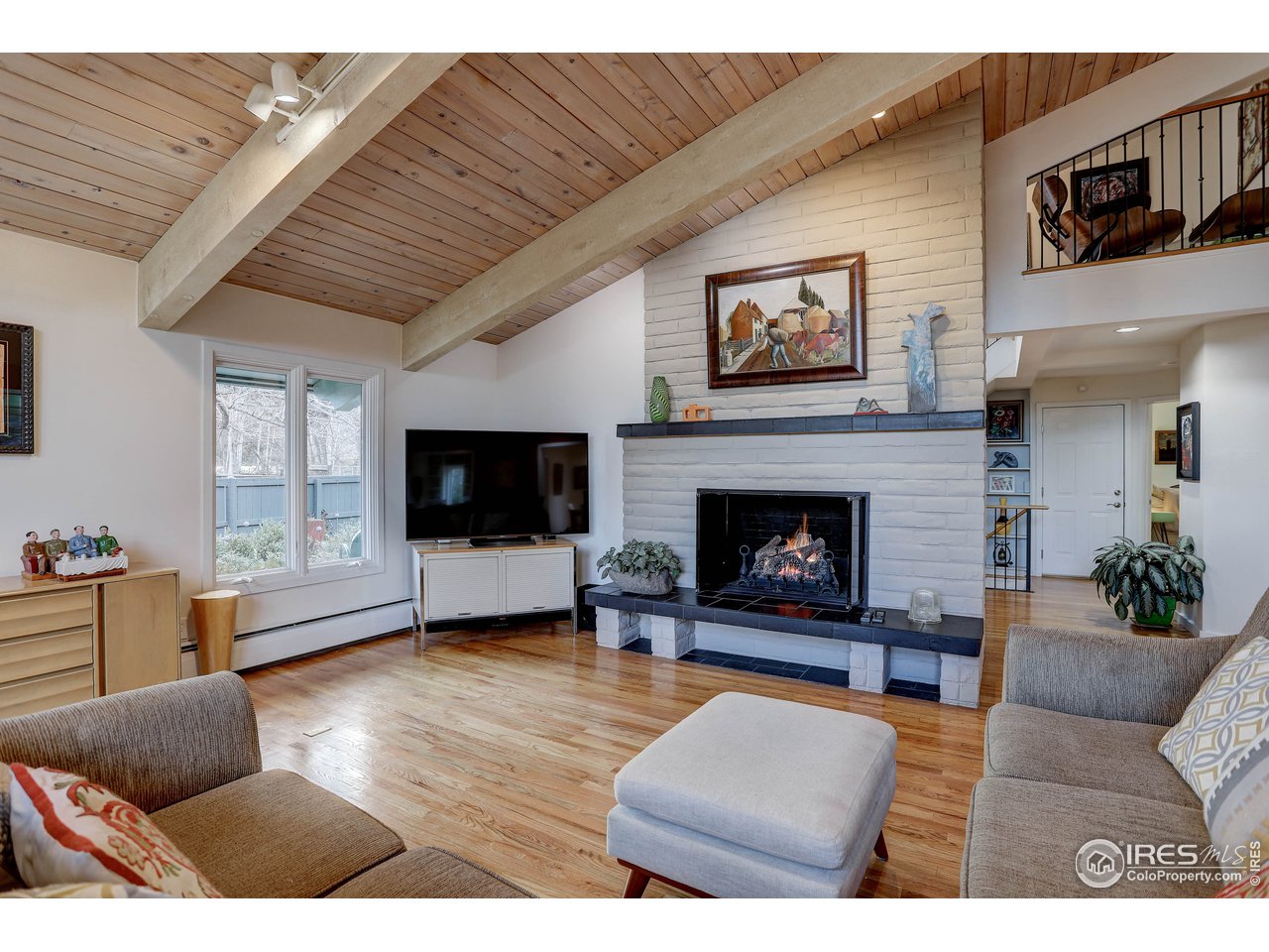 603 Kalmia Avenue Boulder, CO 80304 - Photo 10 of 39 a living room with furniture a flat screen tv and a fireplace