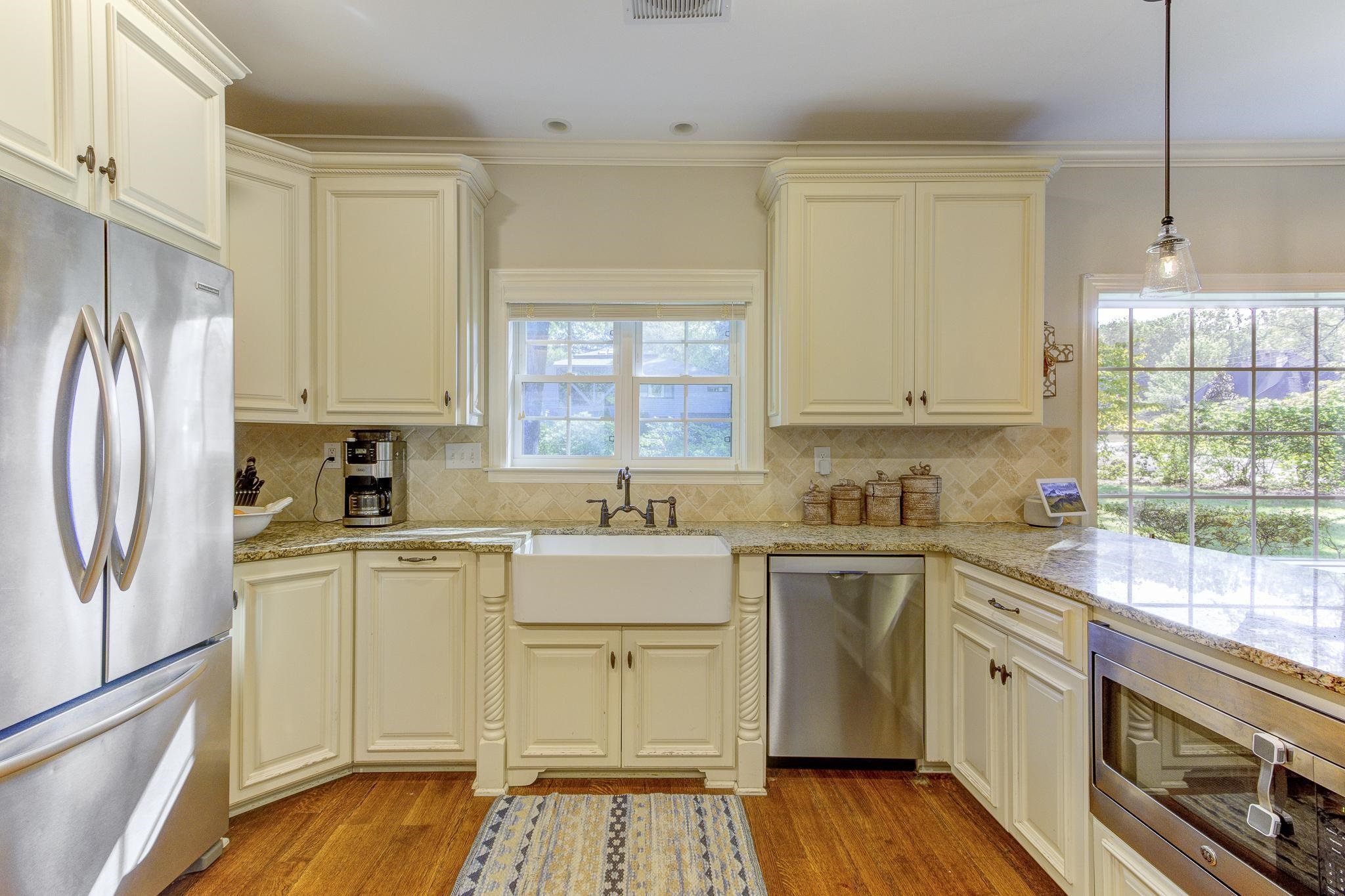 4414 Walnut Grove Road Memphis, TN 38117 - Photo 12 of 40 a kitchen with a white cabinets and wooden floor