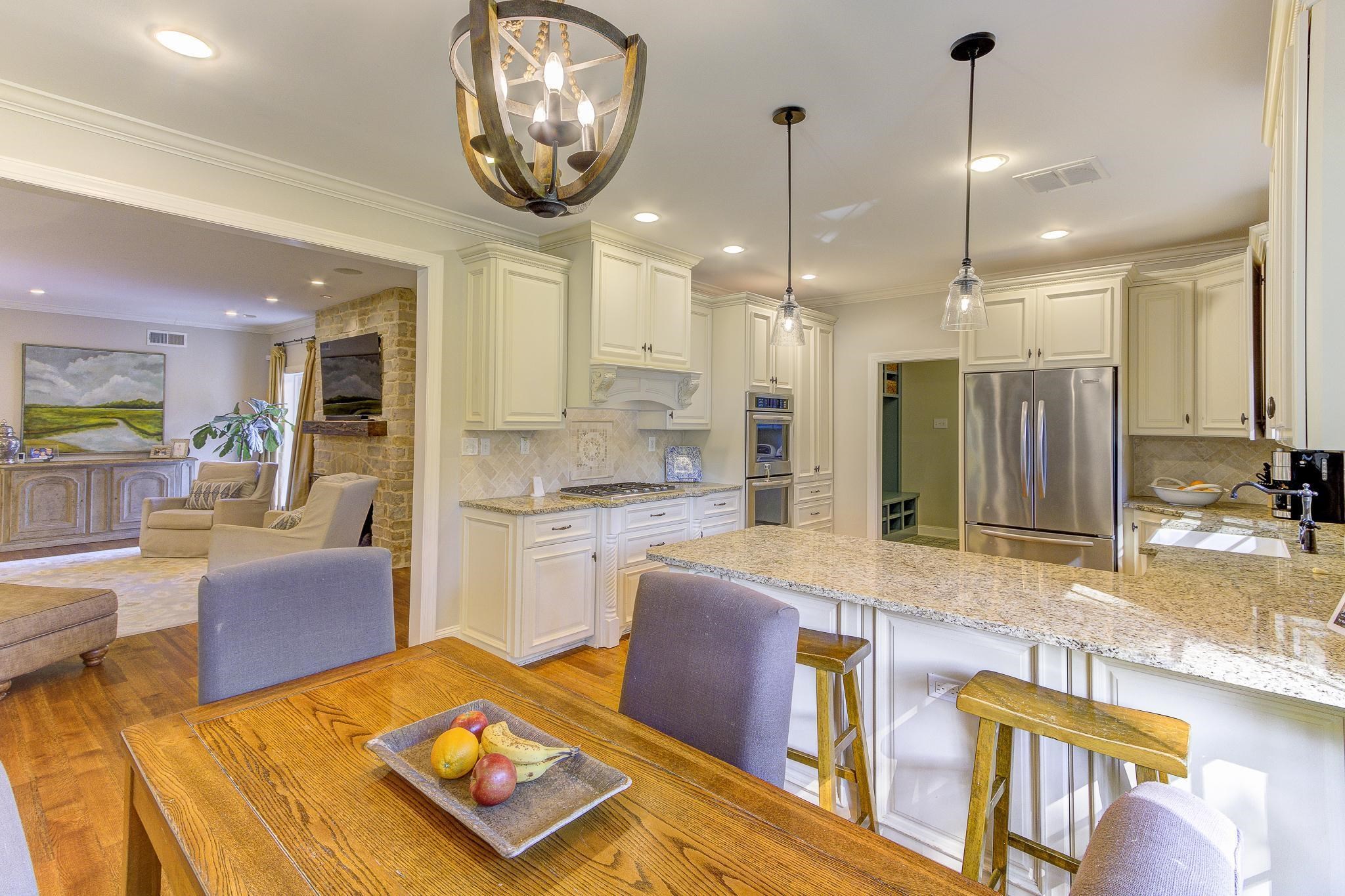 4414 Walnut Grove Road Memphis, TN 38117 - Photo 15 of 40 a large kitchen with kitchen island granite countertop a large center island a stove a sink a dining table and chairs