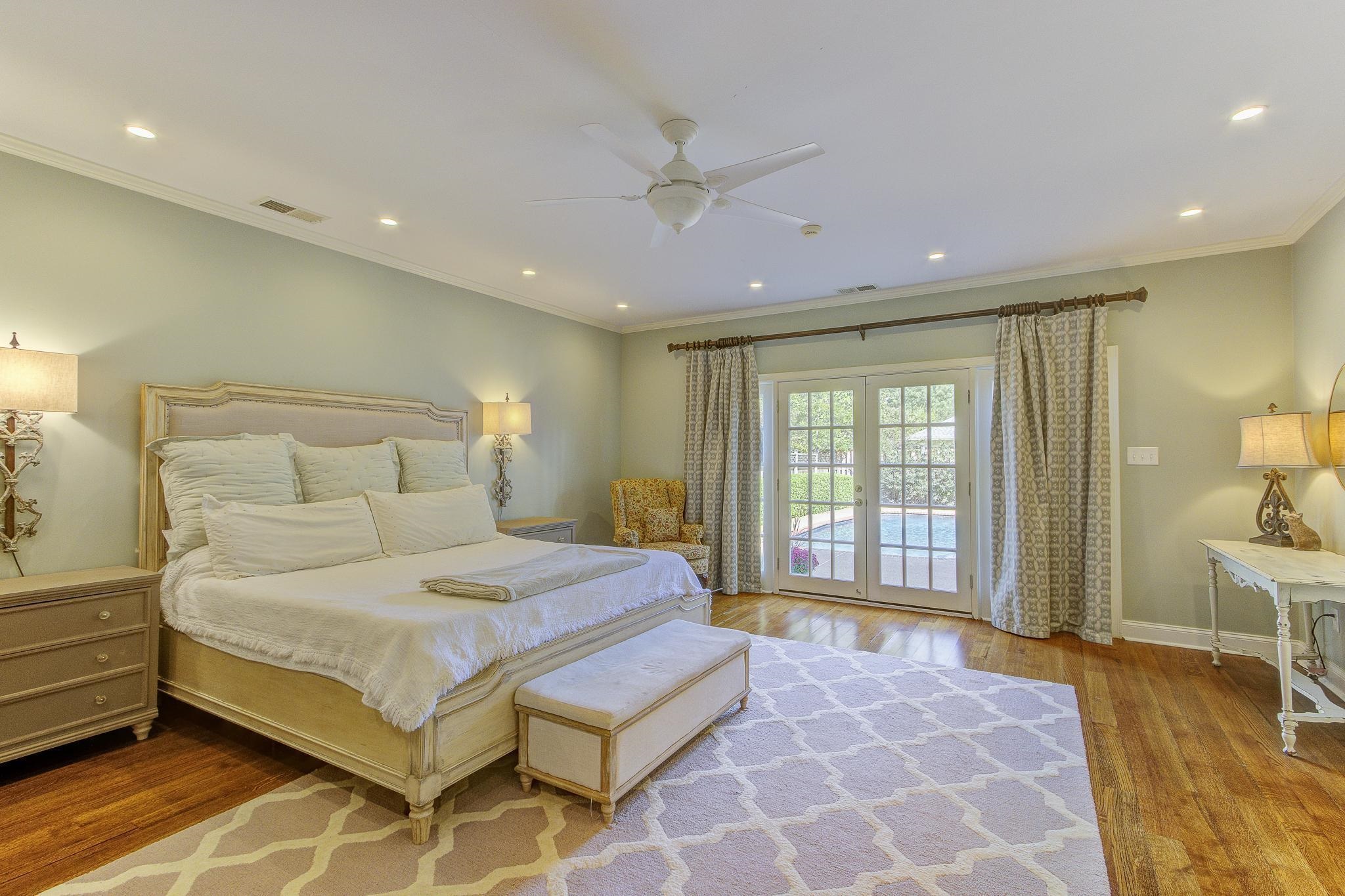 4414 Walnut Grove Road Memphis, TN 38117 - Photo 23 of 40 a bedroom with a large bed and a chandelier